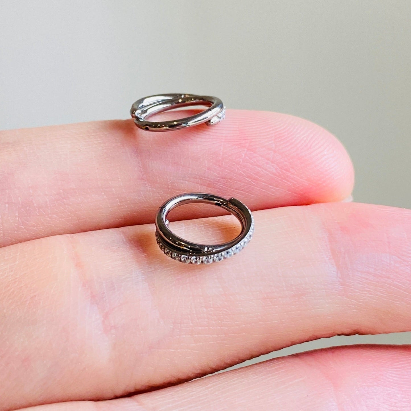 Steel Paved CZ Crisscross Hinged Segment Clicker Ring